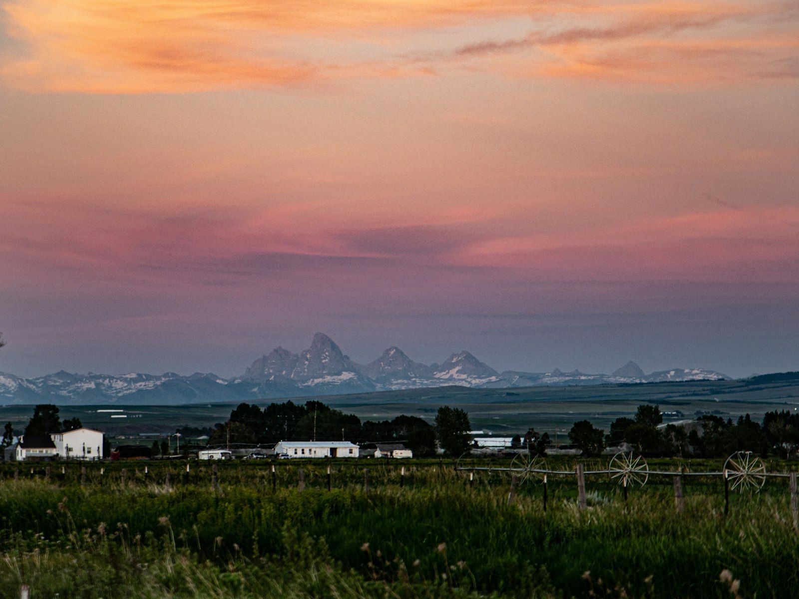 The Teton range seen from the Idaho side, rising above ranch land in the Snake River valley